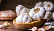 Garlic Cloves and Bulb in vintage wooden bowl.