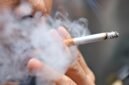 Smoking a cigarette with smoke around and a blurred background