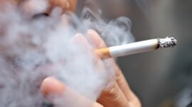 Smoking a cigarette with smoke around and a blurred background