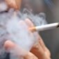 Smoking a cigarette with smoke around and a blurred background