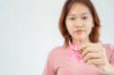 Woman hold pink ribbon breast cancer awareness. Female health check consciousness. international Women Day and World Cancer Day. sign cancer, Symbolic, health care, support patients, timely diagnosis