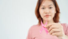 Woman hold pink ribbon breast cancer awareness. Female health check consciousness. international Women Day and World Cancer Day. sign cancer, Symbolic, health care, support patients, timely diagnosis