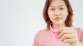 Woman hold pink ribbon breast cancer awareness. Female health check consciousness. international Women Day and World Cancer Day. sign cancer, Symbolic, health care, support patients, timely diagnosis