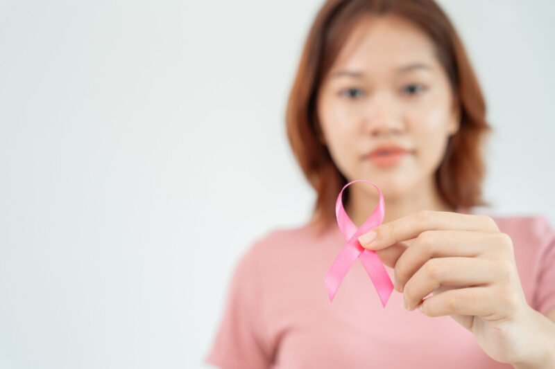 Woman hold pink ribbon breast cancer awareness. Female health check consciousness. international Women Day and World Cancer Day. sign cancer, Symbolic, health care, support patients, timely diagnosis