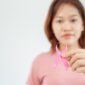 Woman hold pink ribbon breast cancer awareness. Female health check consciousness. international Women Day and World Cancer Day. sign cancer, Symbolic, health care, support patients, timely diagnosis